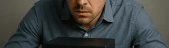 AI Explainability - Male looking into a black box with question marks hovering over the box. He looks confused.